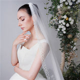 Bride long trailing pearl veil